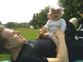 Baby playing with daddy in the park