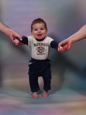 Lukas holding mommy and daddy's hand
