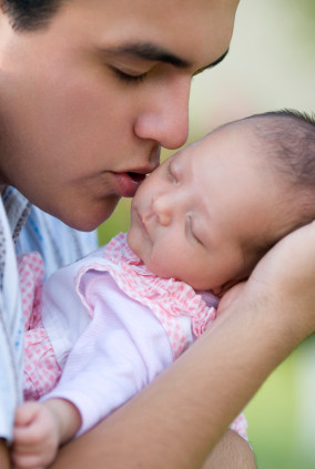 Dad and newborn baby tender moment