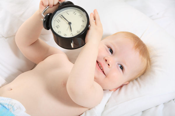 Baby with alarm clock