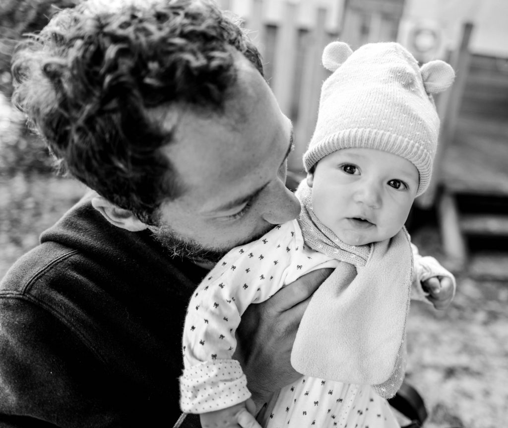 Dad holding baby daughter