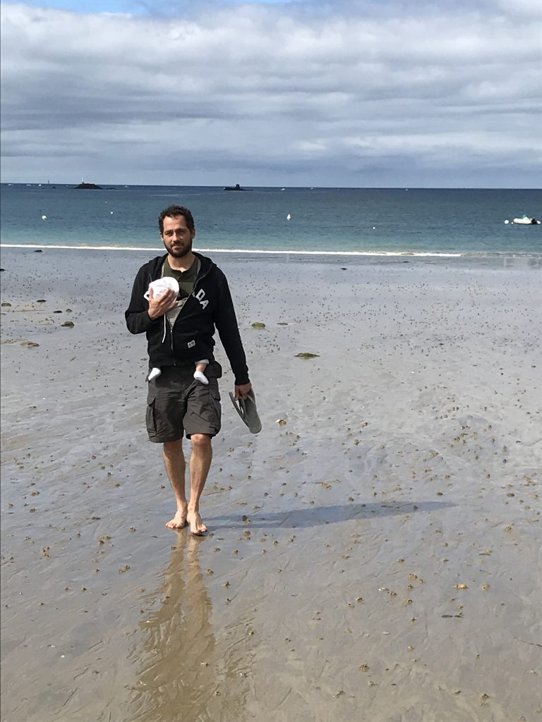 Dad on beach with baby in carrier