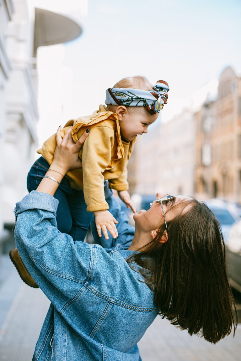 Mom and baby girl playing in the street