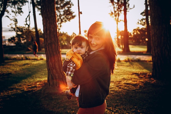 Mom and toddler in bright sun to help with sleep when the clocks change