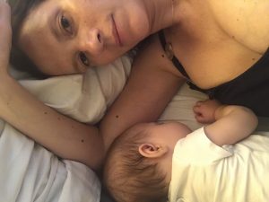 A mom and toddler facing the camera