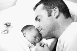 Newborn sleeping near daddy