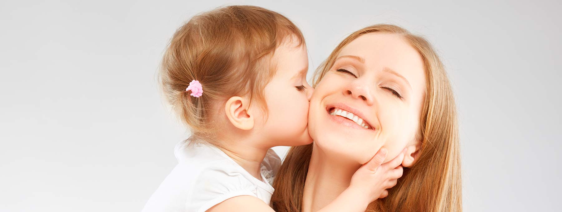 Baby girl giving mommy a kiss