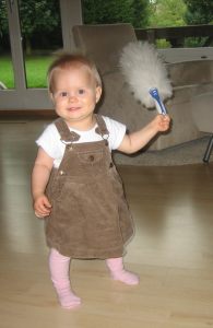 Eleven months old baby standing up cleaning